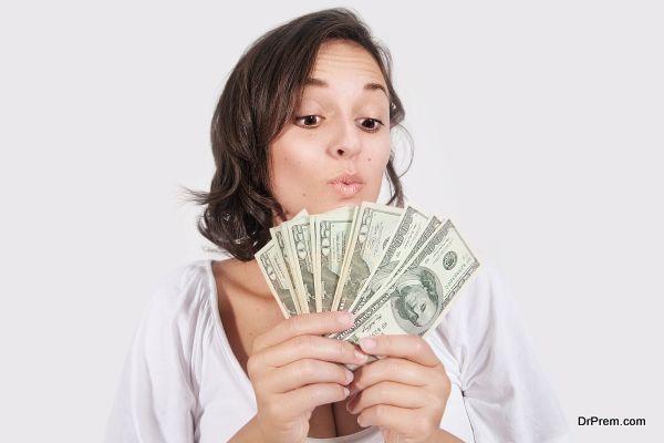 Female holding Money in Amazement