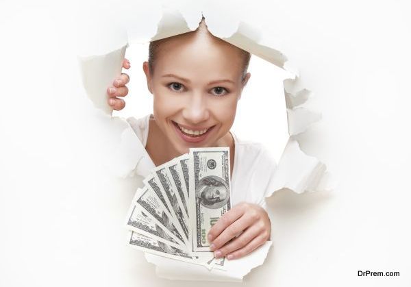 financial concept, woman with money peeking through hole in paper