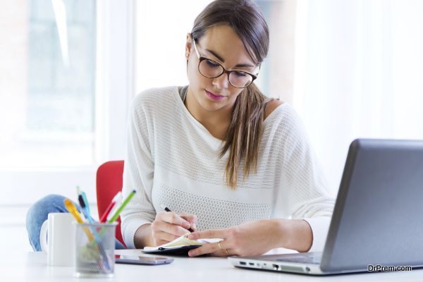 Pretty young woman working in her office.