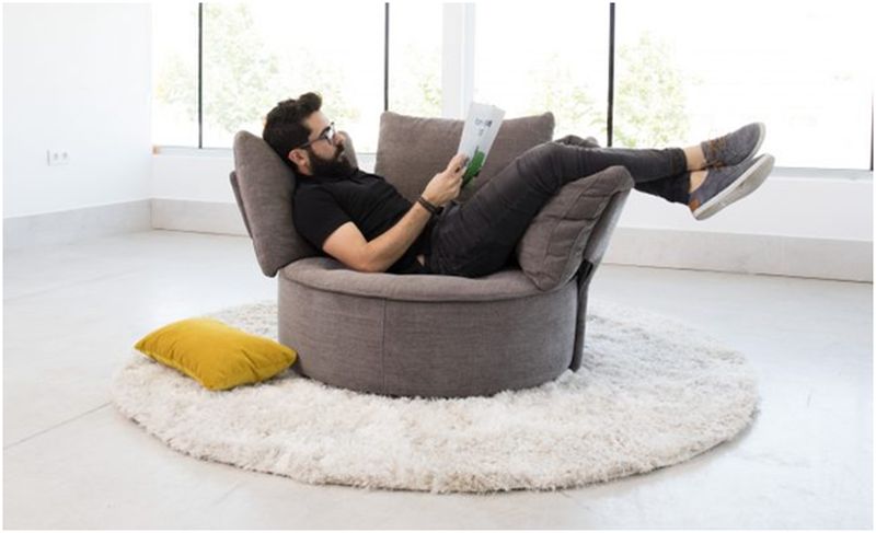 man reading a book on recliner