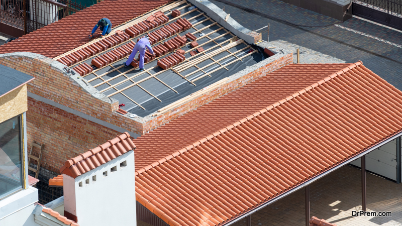 professional roofers standing on new roof
